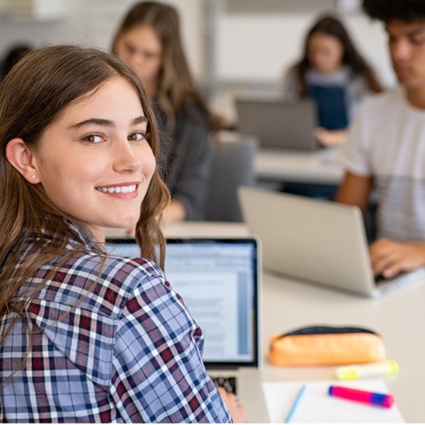 happy-smiling-college-girl-studying-on-laptop-picture-id1278979696_1.jpg